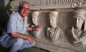 A 2002 picture of Khaled al-Asaad in front of a rare sarcophagus from Palmyra depicting two priests dating from the first century. Photograph: Marc Deville/Gamma-Rapho via Getty Images